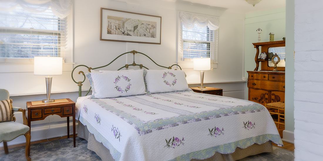 Garden Suite at Oakland Cottage, king bed in a bright room