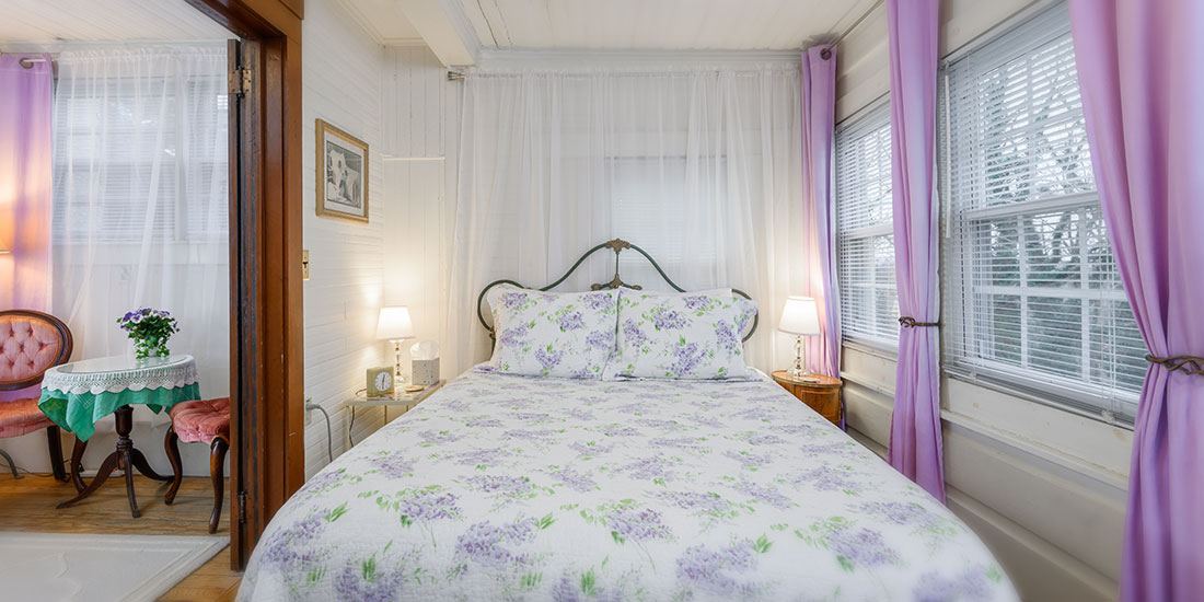 Little Garden Room at Oakland Cottage, queen bed with a bank of windows